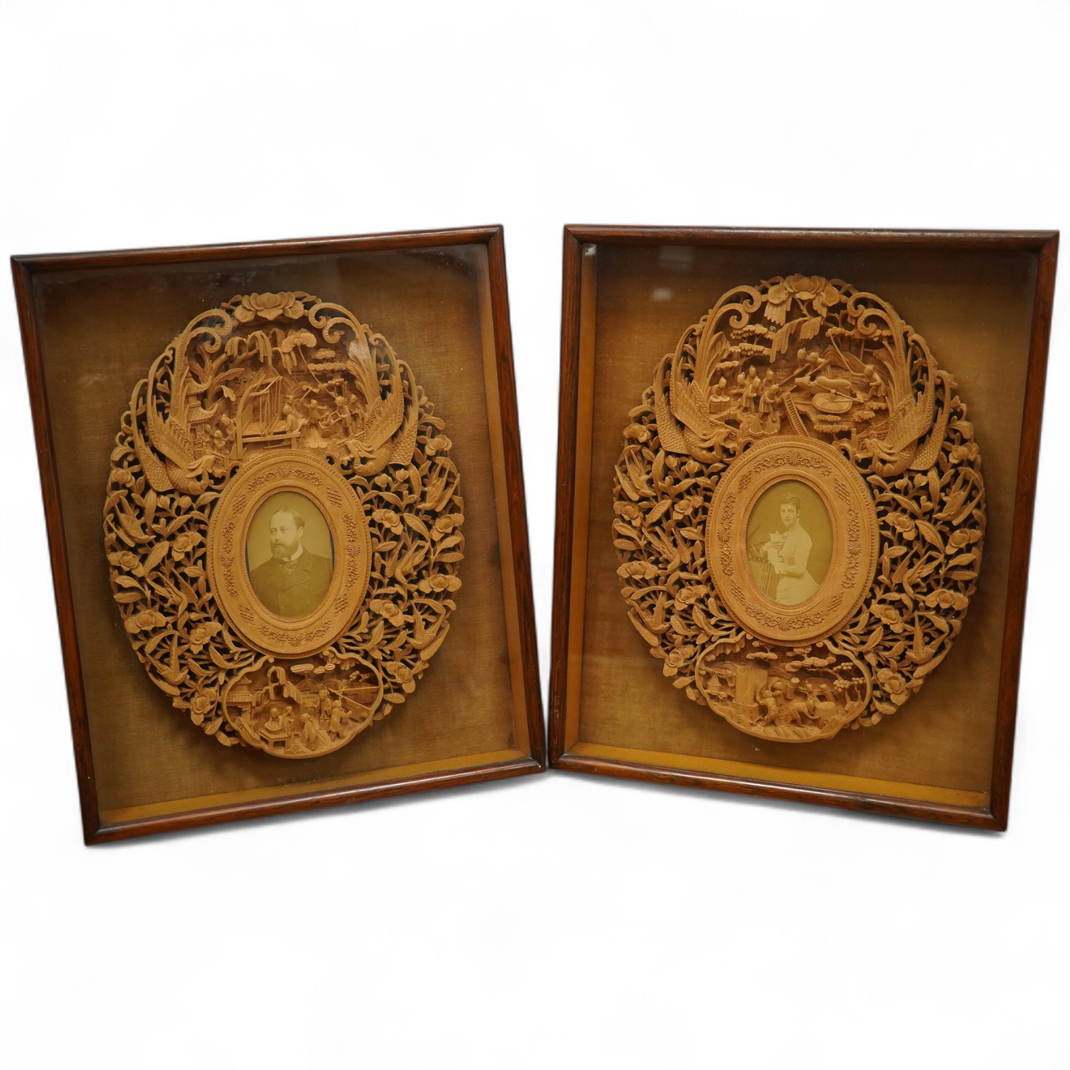 A pair of early 20th century, finely carved Chinese sandalwood photo frames, 30.5cmx24cm oval. Condition - good